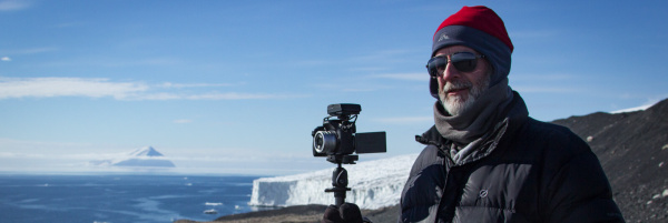 Anthony at top of Cape Bird banner